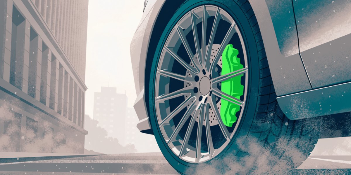Close view of a van wheel with the brake caliper visible and fine dust drifting from the brake and tyre