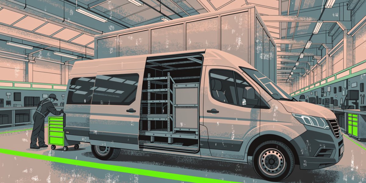 A large panel van being fitted with racking in a conversion workshop while a fitter works at the side door