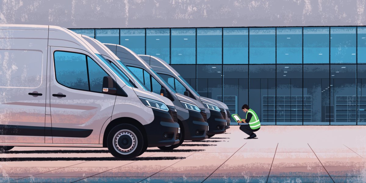 A row of new panel vans on a dealer forecourt while a technician in a hi-vis vest checks the nearest one with a tablet